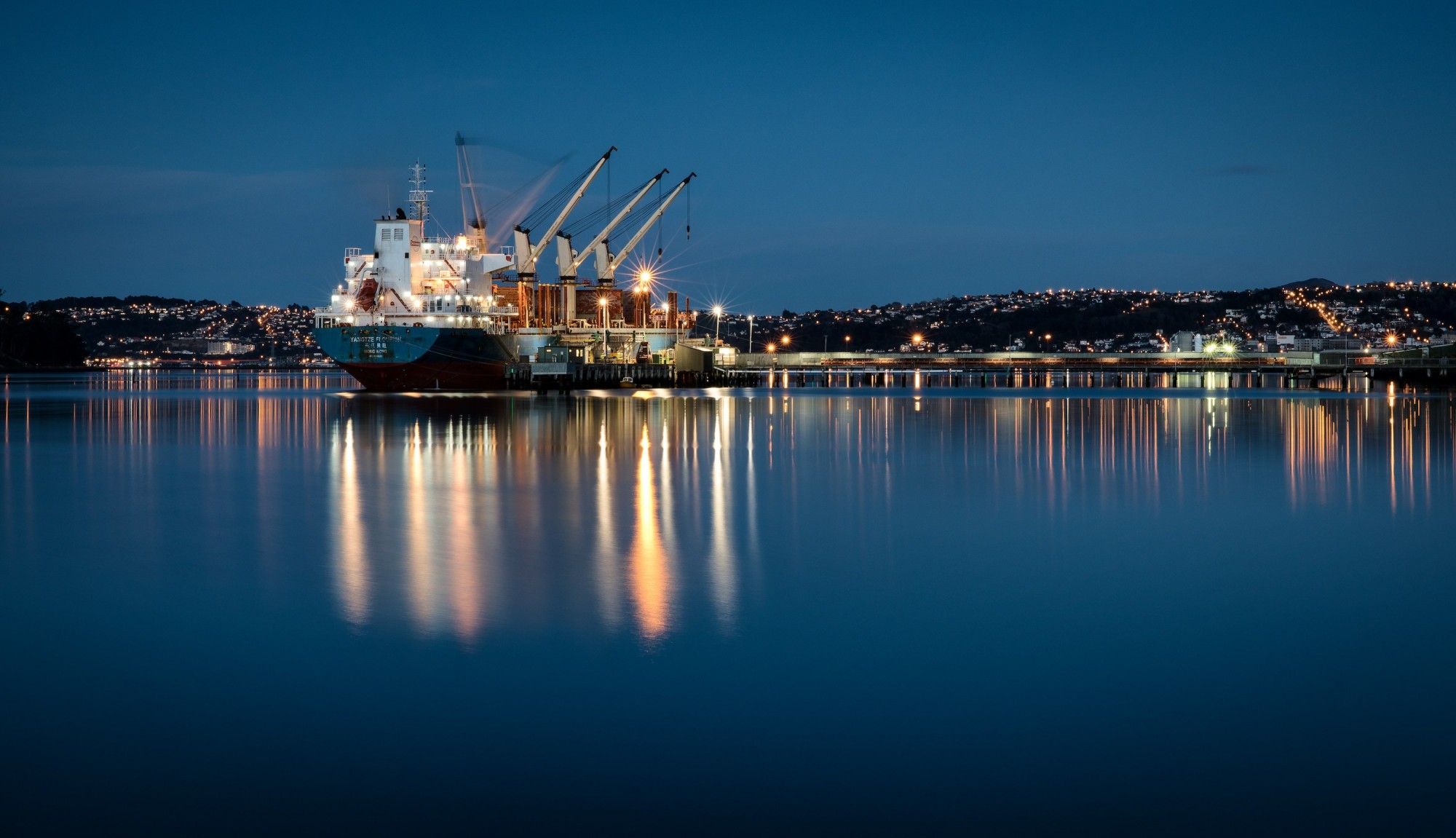 A well-lit cargo ship at night time on Dunedin harbour